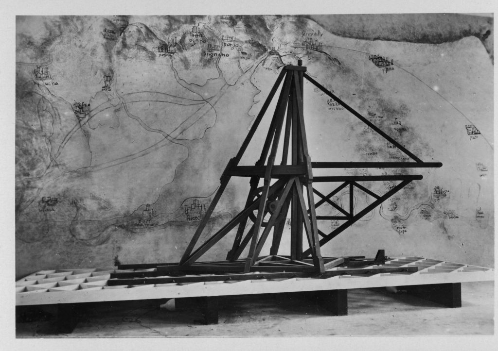 Black and white photograph of a large wooden model of a canal excavating machine
