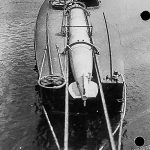 Black and white photograph of a coastal motor boat with a loaded torpedo