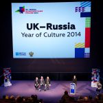 Colour photograph of the UK & Russia year of culture press conference showing a discussion panel and large projection