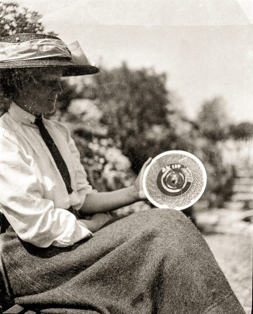 Black and white photograph of Blanche Thornycroft holding a disc used for recording test data