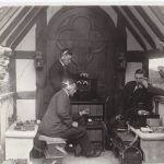 Black and white photograph of wireless engineers using early recording equipment in preparation for a recording at Foyle Riding