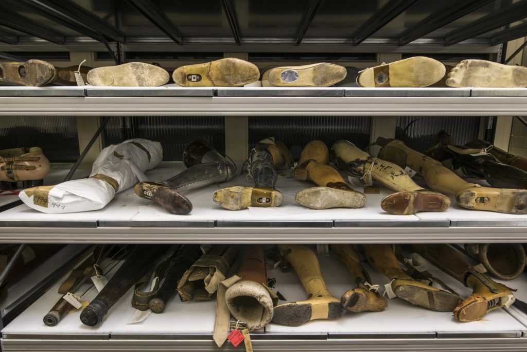 Colour photograph of prosthetic limbs in shelving storage