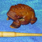 Colour photograph of an historic wooden percussion instrument in the shape of a frog