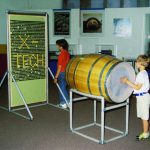 Colour photograph of museum goers using display items at a museum science centre