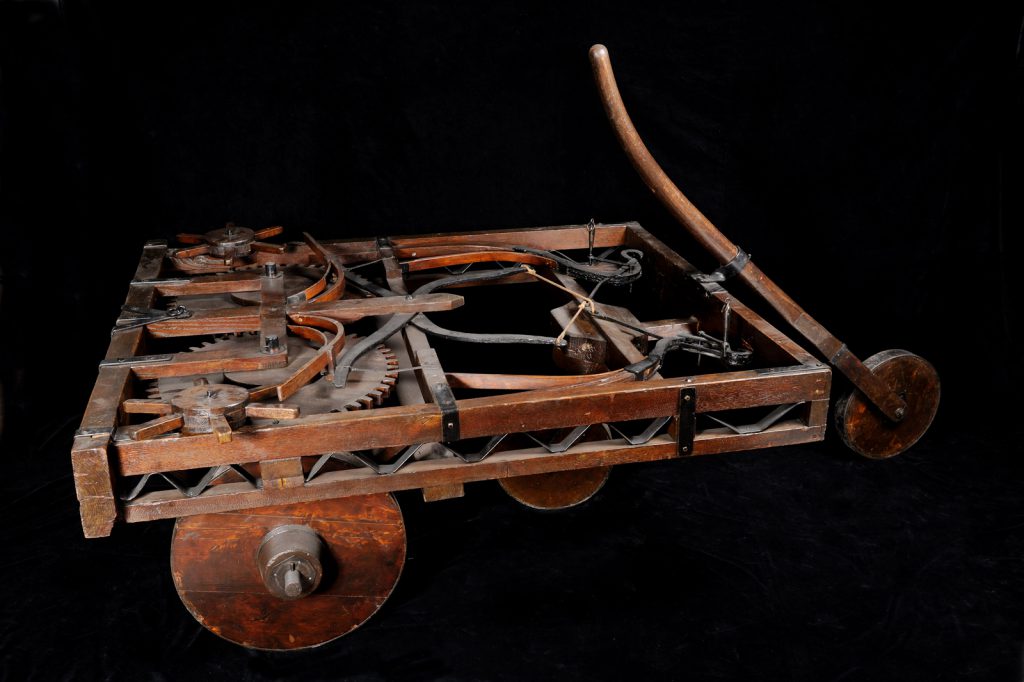 Colour photograph of a wooden model of a self propelled car