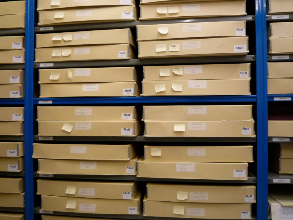 Colour photograph showing shelves of boxes containing photographs