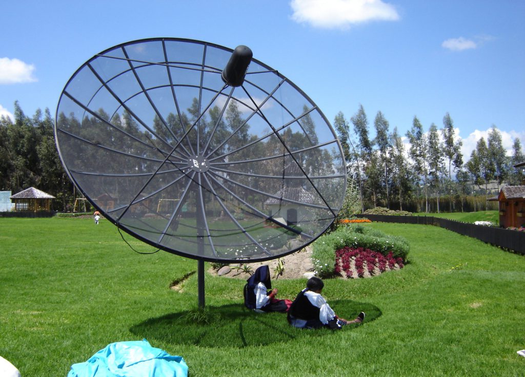Two Ecuadorian women adapt technology to their own lives by creating a sunshade out of a satellite dish