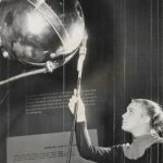 Black and white photograph of a girl touching the antenna of the Sputnik satellite