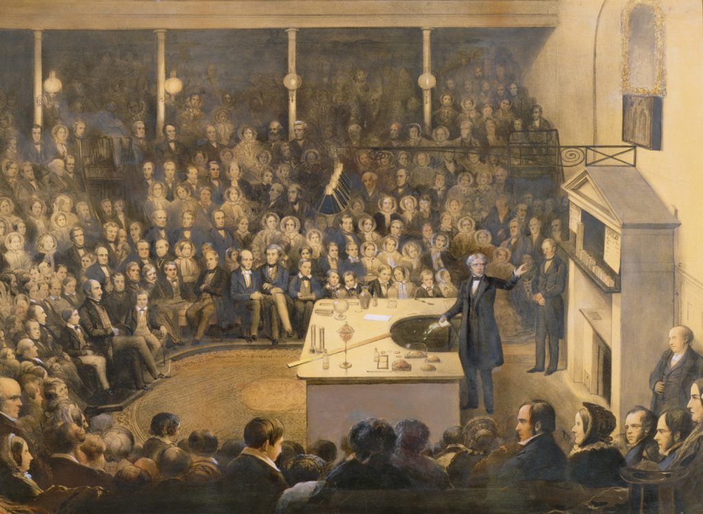Coloured lithograph of Michael Faraday lecturing in the Theatre at the Royal Institution circa 1856