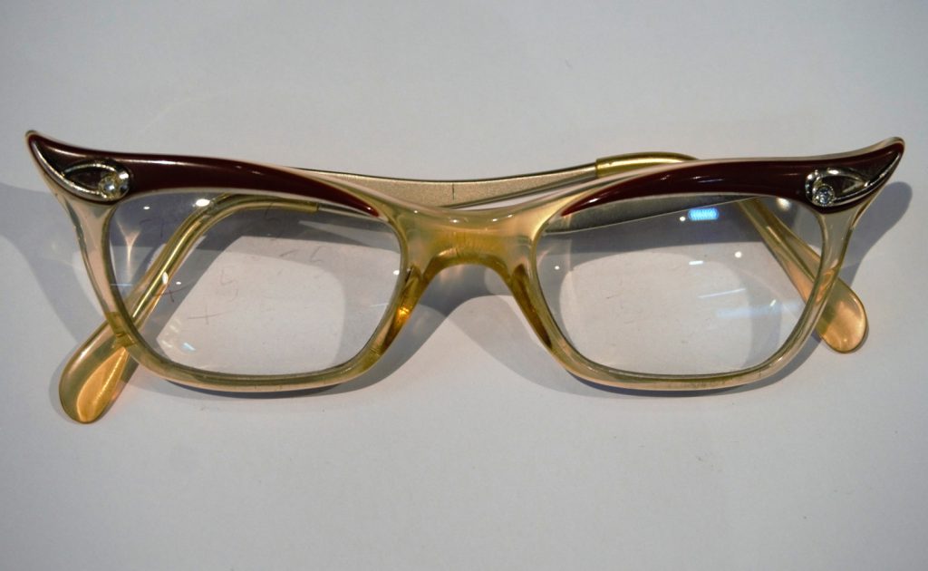 Colour photograph of a pair of hybrid Candida frame NHS spectacles
