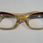 Colour photograph of a pair of hybrid Candida frame NHS spectacles