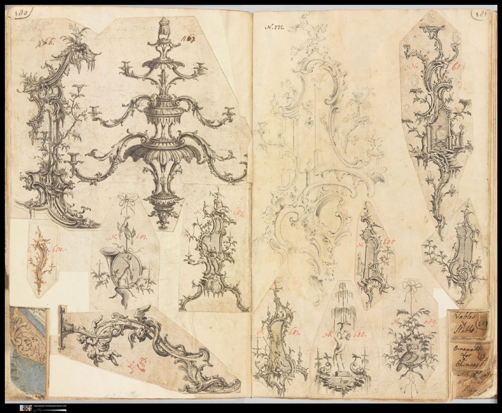 Photograph of scrapbook page spread showing fragments of printed designs of rococo woodworking