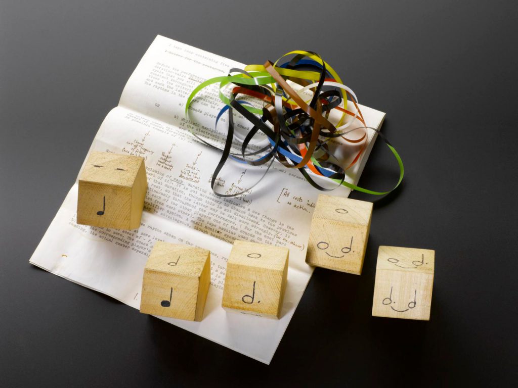 Colour photograph of a score by Graham Hearn for Hugh Davies comprising five wooden pentagons and a tape loop
