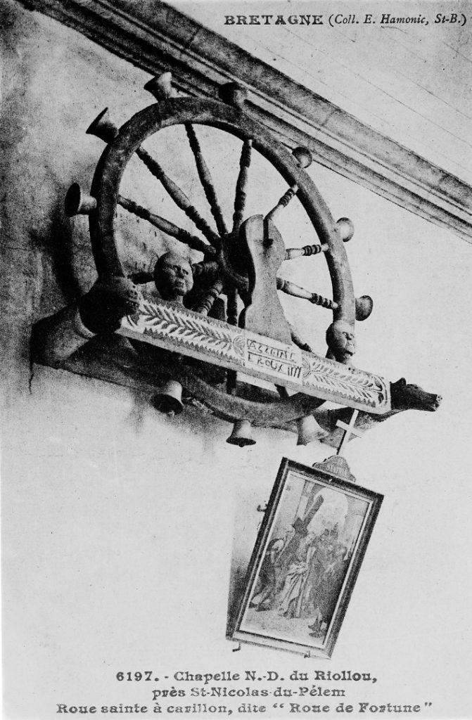 Black and white photograph of a holy wheel of carillon hanging on a wall