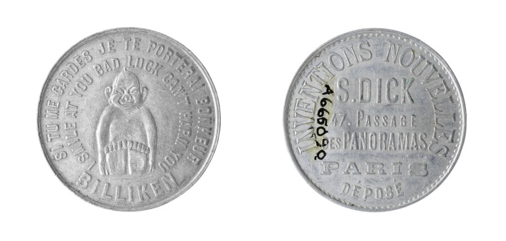 Colour photograph of the front and reverse side of a coin amulet for good luck