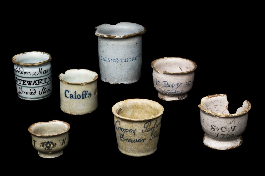 Colour photograph of various nineteenth century tin glazed earthenware dispensing pots