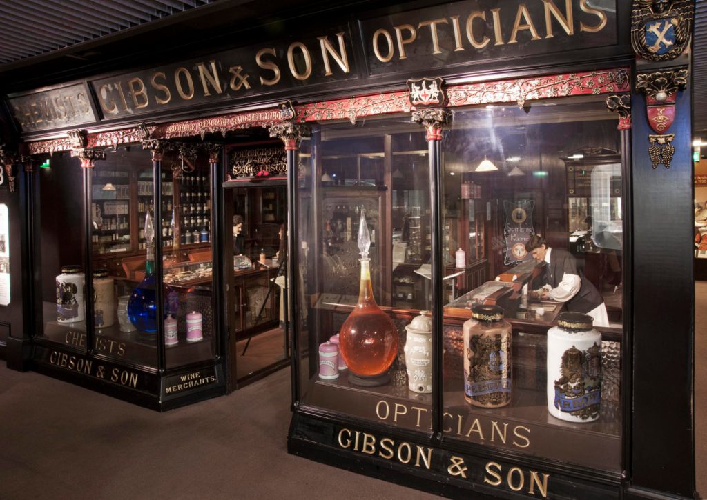 Colour photograph of a lifesize model of the shop front of a victorian era chemists