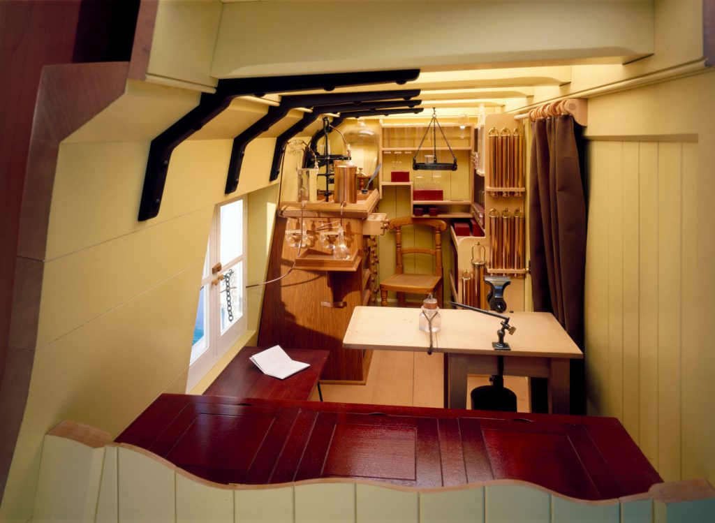 Colour photograph of the interior of a scale model of the chemistry laboratory of HMS Challenger 1872 to 1876