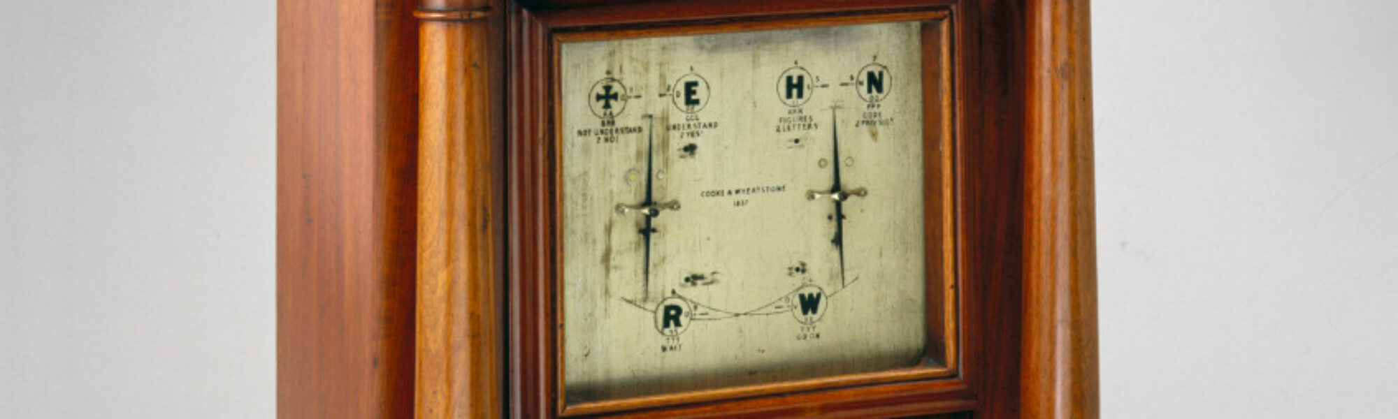 Colour photograph of Cooke and Wheatstone needle instrument from 1837 set in polished wood