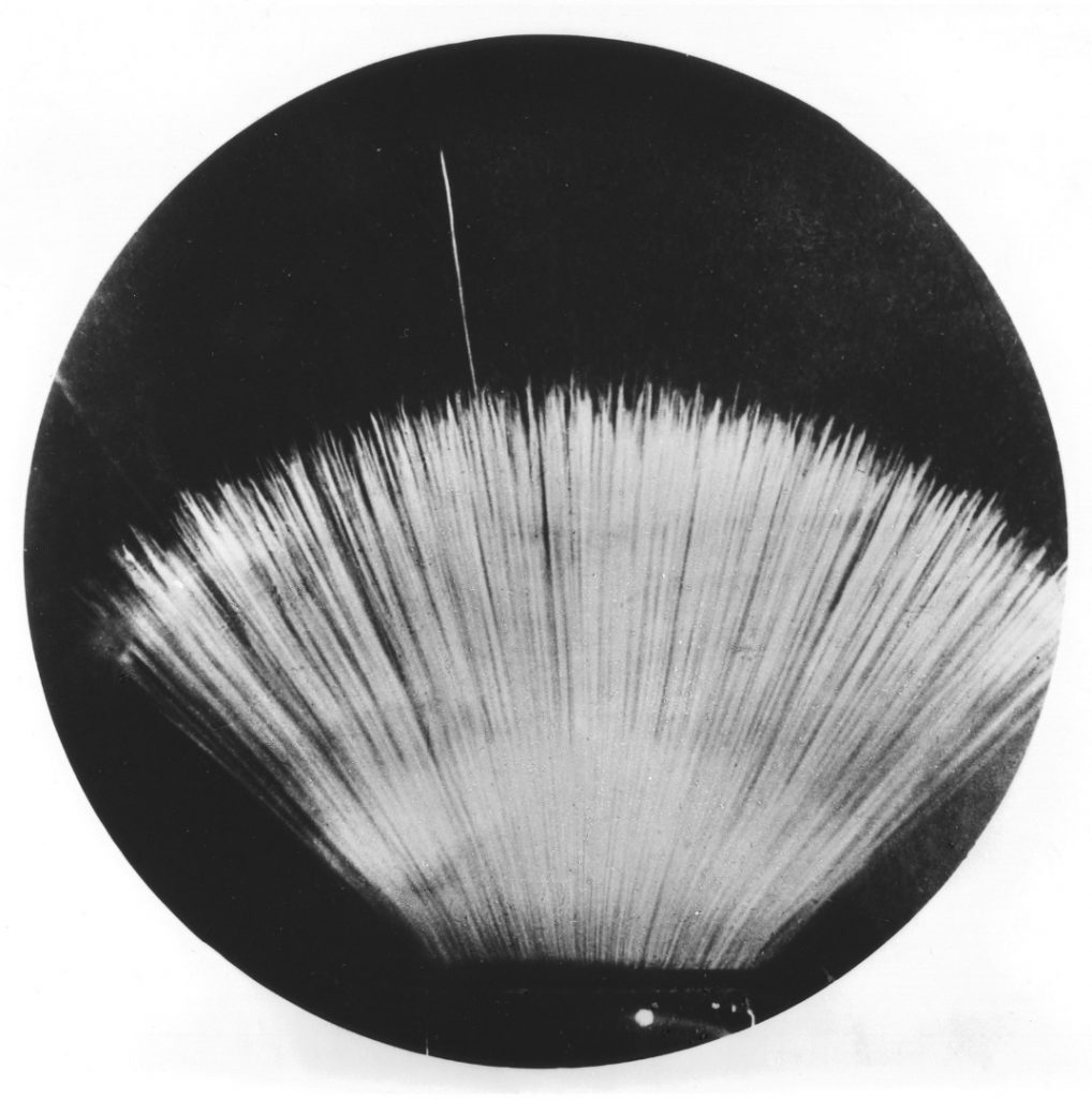 A black and white much magnified photograph from 1937 of a long range alpha particle