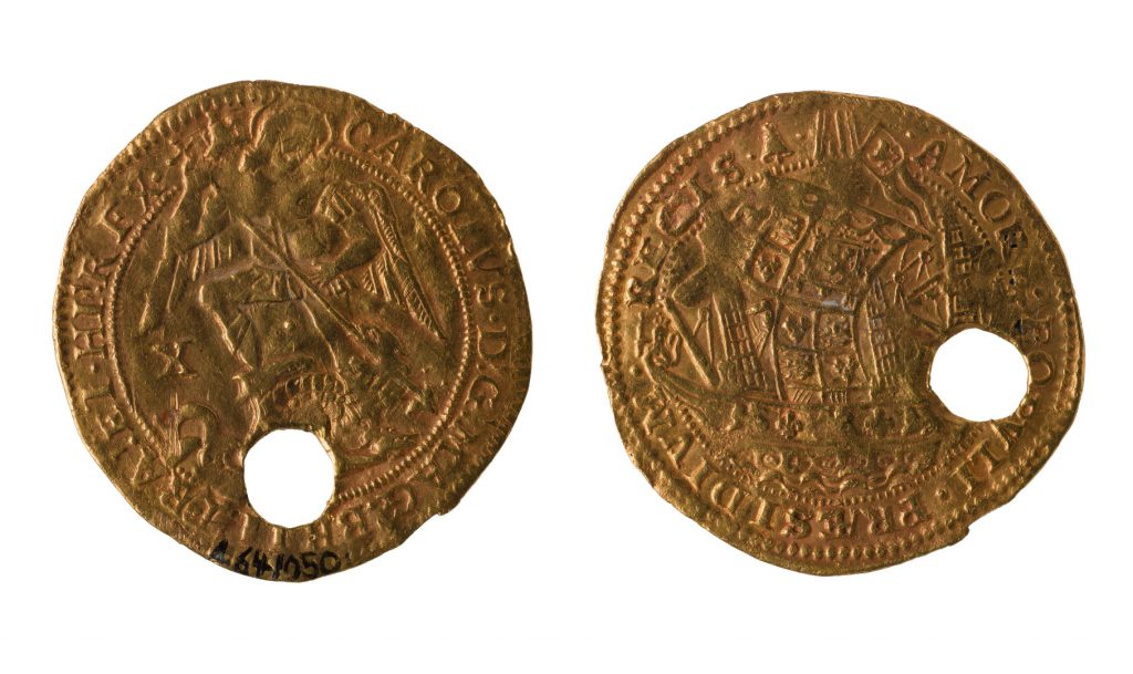 Colour photograph of the front and reverse side of a coin amulet of healing