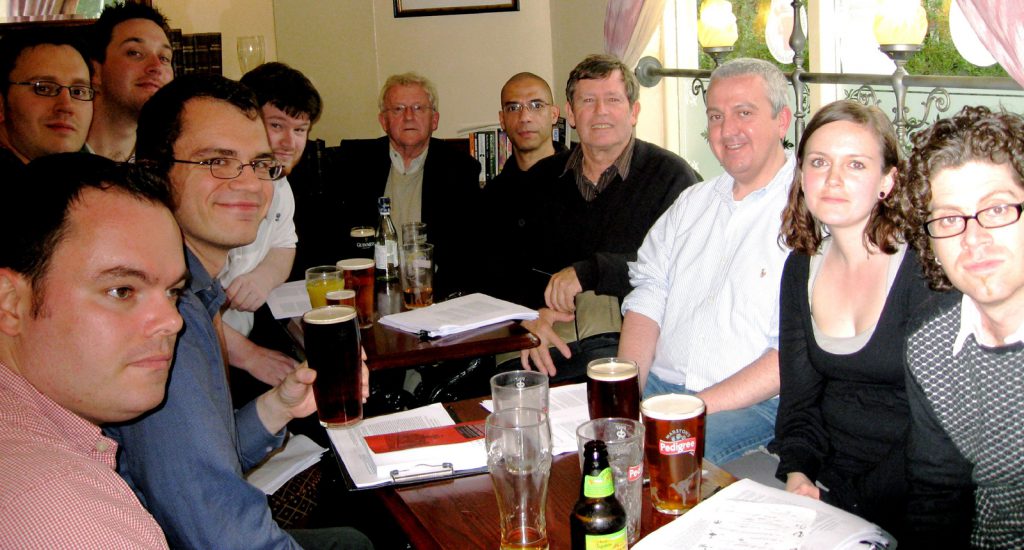 Colour photograph of Jeffs reading group sat inside a pub