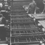 Black and white photograph of a number of people working on a differential analyser machine