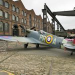 Colour photograph of a renovated Spitfire aircraft outside the Museum of Science and Industry
