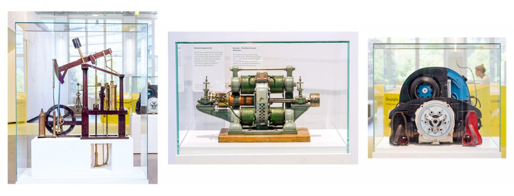 Colour photographs of a steam engine model a dial current generator and an internal combustion engine on display