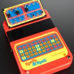 Colour photograph of a speak and spell childrens toy that has been modified to create music