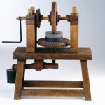 Colour photograph of a working wooden model of a machine for grinding concave mirrors