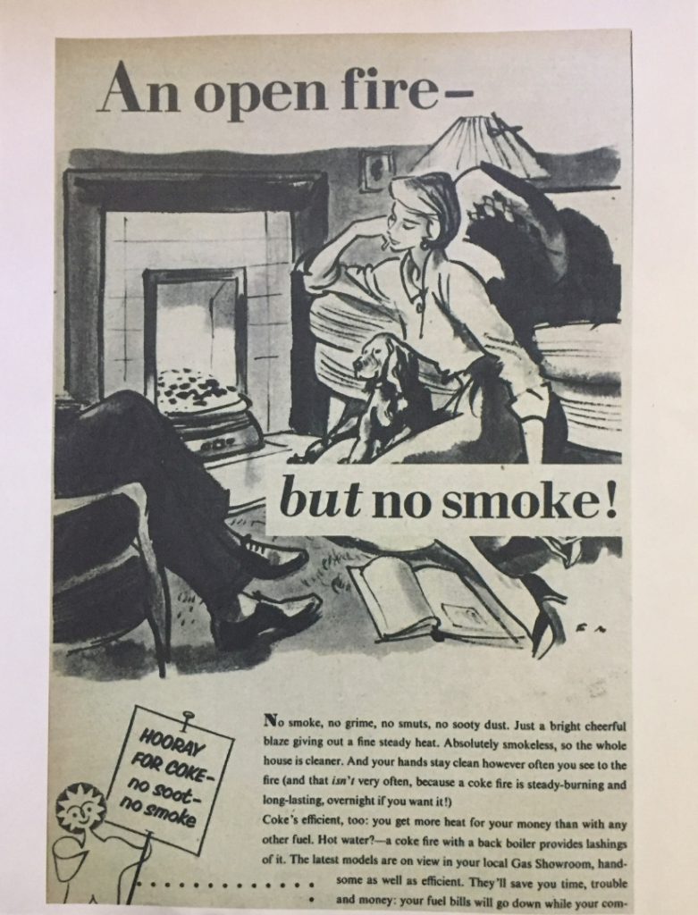 A magazine advertisement showing a couple and their dog around a living room fireplace. The caption reads an open fire but no smoke
