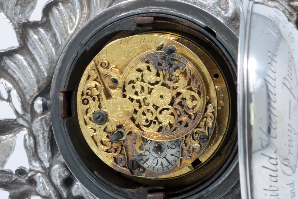 The back of the watch movement of the small clock signed 'H Perry Dean Street St Anns London'