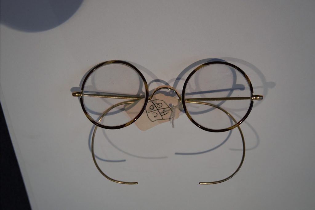 Colour photograph of a pair of Windsor style NHS spectacles with Xylonite covered rims