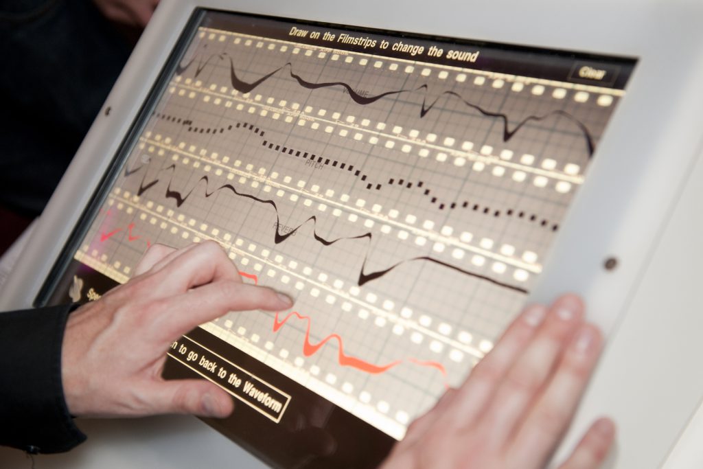 Close up of the Oramics Machine app screen showing strips of acetate and drawn lines as they appear on the machine itself
