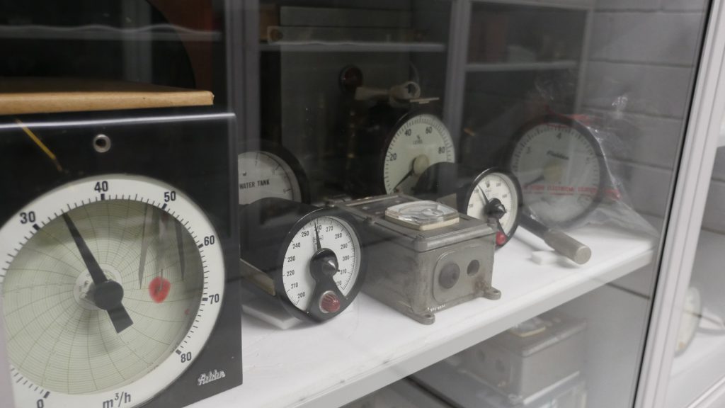 Colour photograph of a number of dials and meters in museum storage