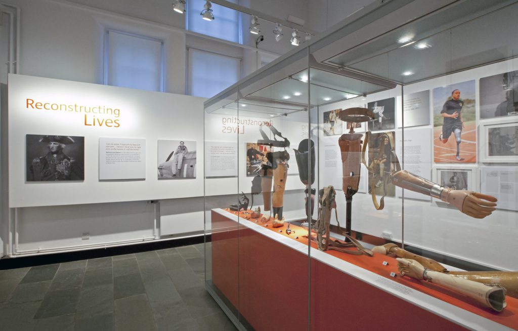 Colour photograph of a display case in an exhibition containing prosthetic limbs