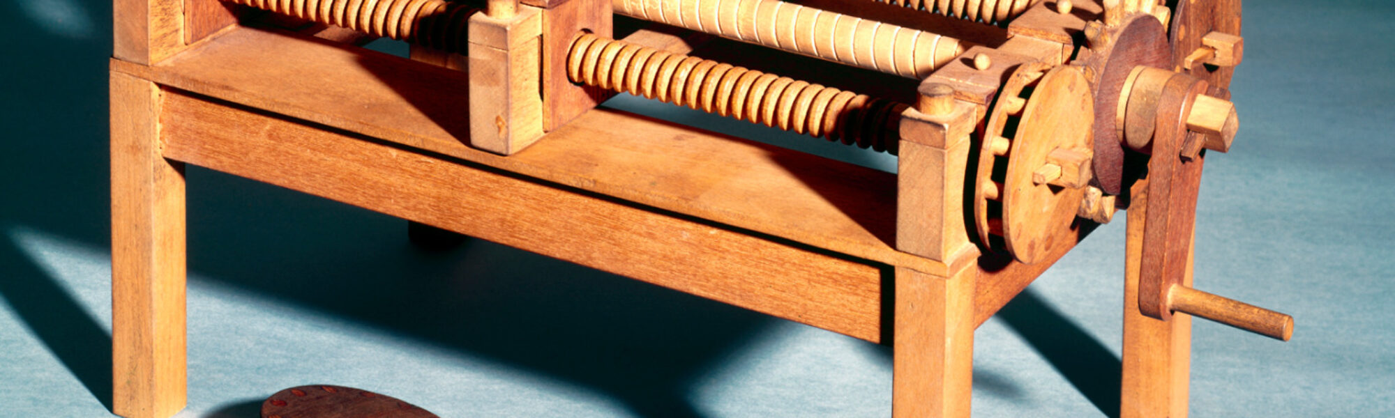 Colour photograph of a working wooden model of a machine for cutting wooden screws