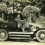 Black and white photograph of an early Renault motor car with chauffeur from the early twentieth century