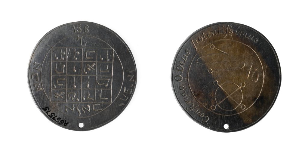 Colour photograph of the front and reverse sides of a coin amulet