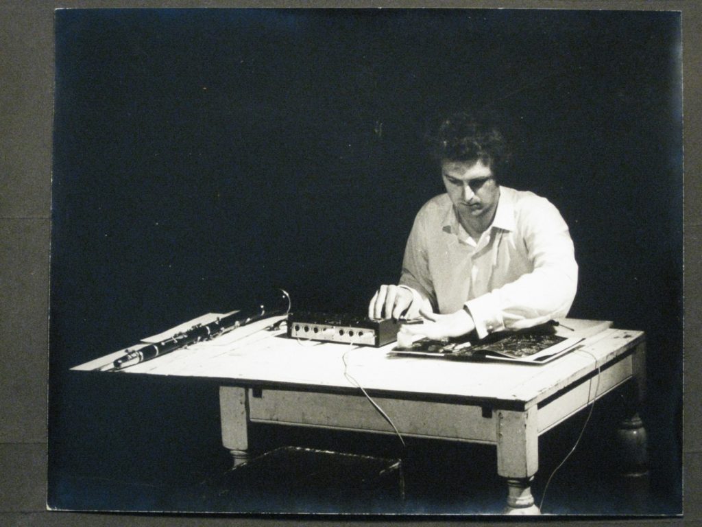 Black and white photograph of Hugh Davies with Shozyg I Uher mixer and clarinet pictured July 1968