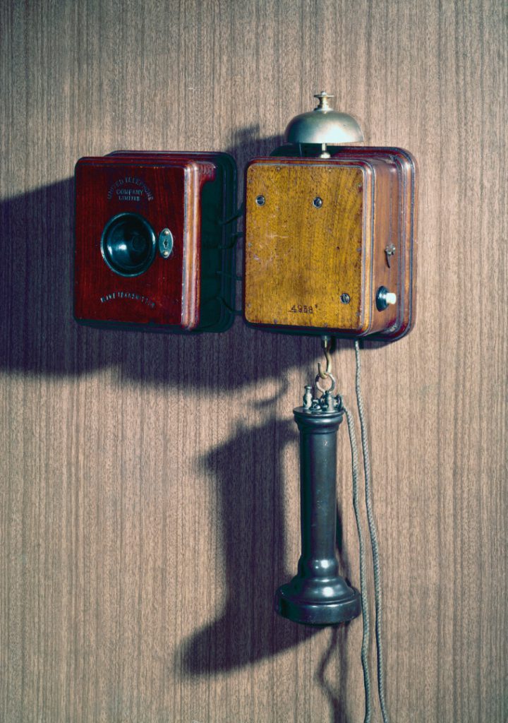 Colour photograph of a wall mounted telephone that uses an Blake transmitter from the 1880s