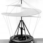 black and white photograph of a working model of a static helicopter sail on a wooden base