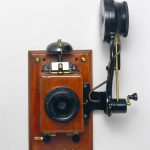 Colour photograph of a wall mounted telephone that uses an Edison chalk receiver from the early 1900s