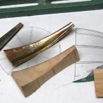 Colour photograph of strips of brass used to fabricate a mouthpiece