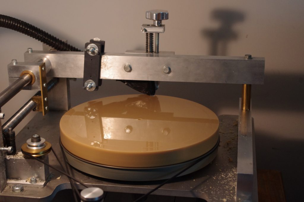 Colour photograph of a wax disc on the wax shaving device