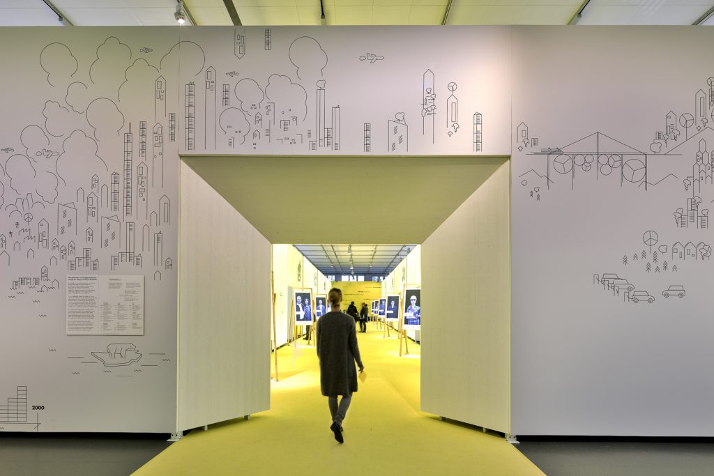 Colour photograph of a visitor entering the doorway of a new exhibition