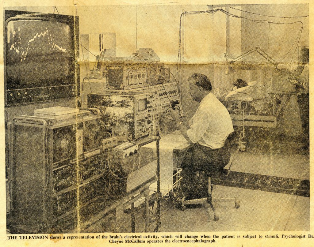 Newspaper clipping showing a psychologist sitting before an electroencephalograph from 1972