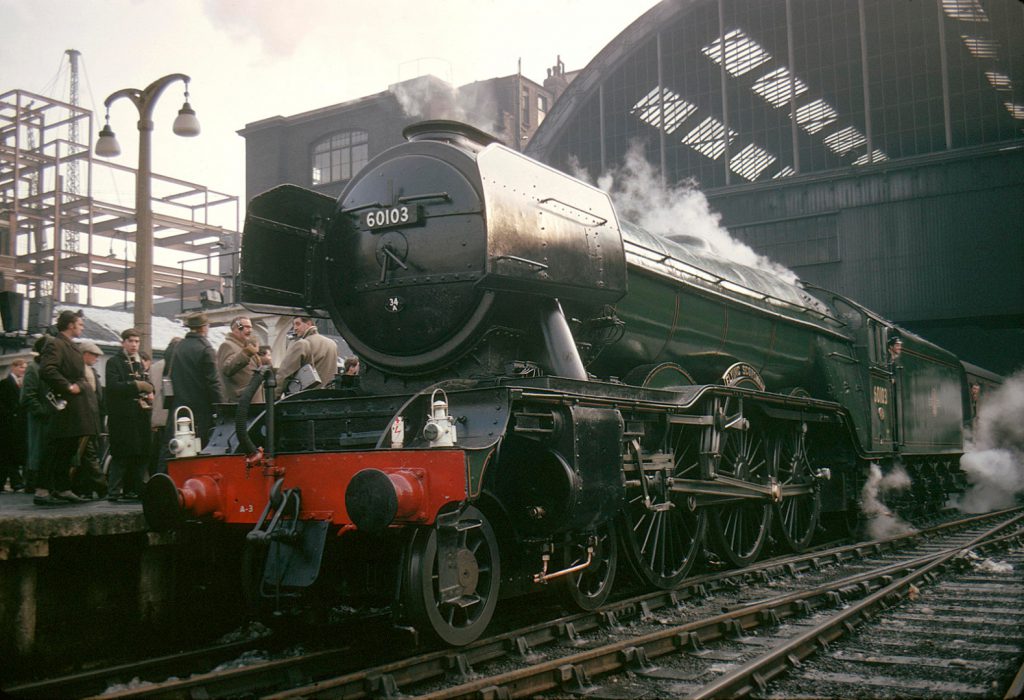 The Flying Scotsman steam train on the tracks at London Kings Cross station