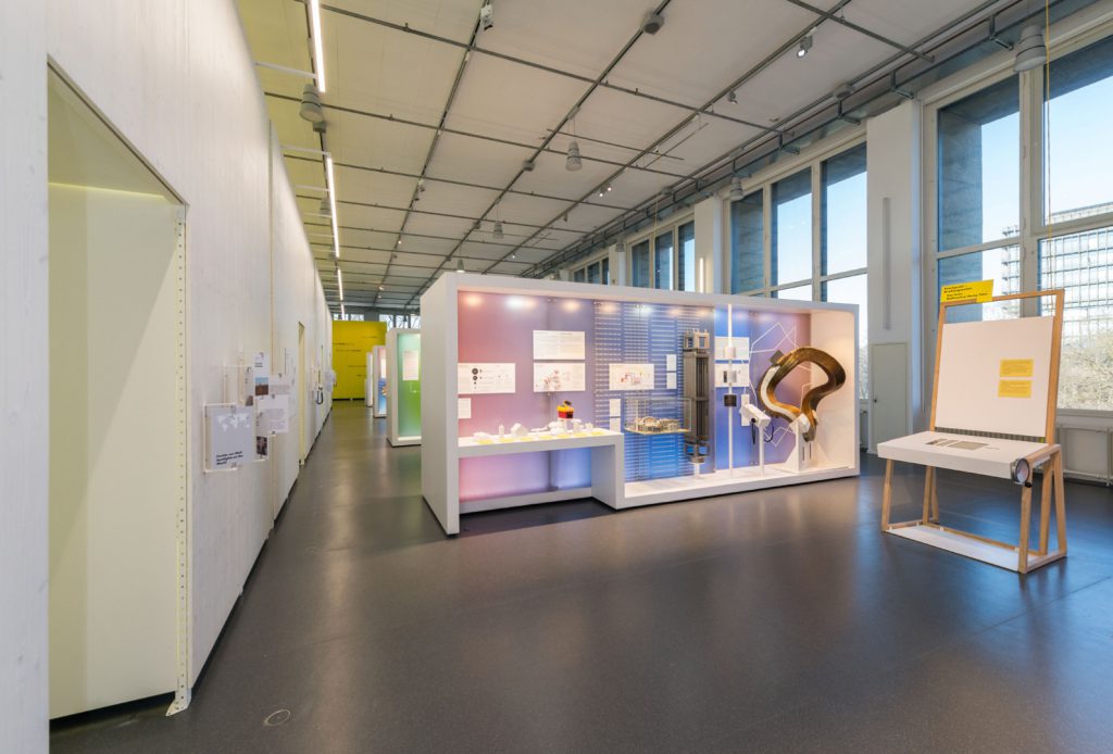 Colour photograph of a bright exhibition space with display objects